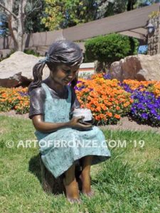 Birthday Wishes side view B bronze statue of girl with birthday cake