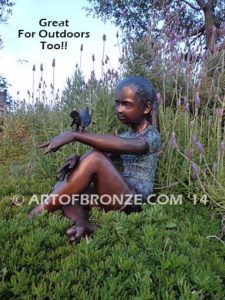 Garden Help bronze sculpture of girl sitting with crossed legs and bird on her hand