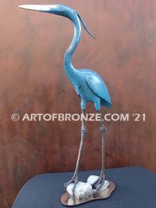 Heron in Everglades sculpture heron standing on rocks by British artist Brian Arthur