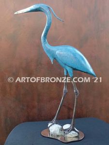 Heron in Everglades sculpture heron standing on rocks by British artist Brian Arthur