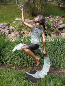 Enchanted Butterfly fantasy bronze sculpture of girl sitting on giant leaf with butterfly