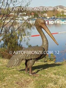 Heavenly Retreat bronze statue of resting pelican standing and looking for fish