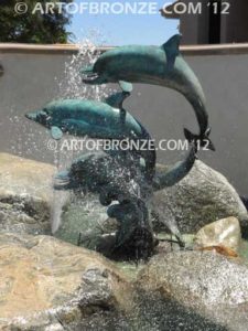 Soul Surfers marine life bronze cast three dolphin sculpture monument