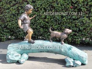 Adventurous Pals Bronze monumental sculpture for garden or yard of boy and dog crossing bronze log