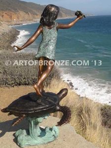 A Treasured Day Bronze sculpture of whimsical girl on turtle playing with seashell