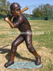 Home Run bronze sculpture of boy playing baseball hitting ball