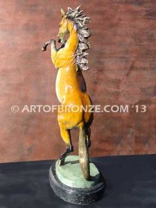 Sunfire sculpture of reared horse with contemporary brilliant patina coloring attached to marble base