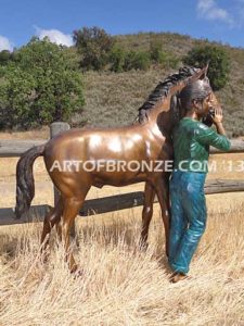 Dreams Come True bronze sculpture of girl petting her pony horse