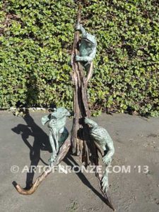 Playground three bronze bullfrogs playing on branches for garden or outdoor display