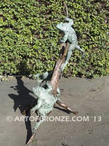 Playground three bronze bullfrogs playing on branches for garden or outdoor display