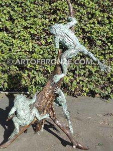 Playground three bronze bullfrogs playing on branches for garden or outdoor display