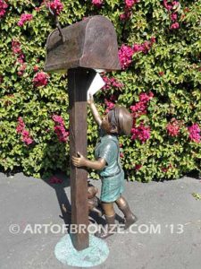Letter to Grandma sculpture of dog and boy putting letter to grandma in mailbox