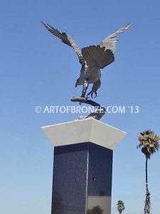 Eagle Veteran Memorial outdoor monumental statue of an eagle landing atop granite pillar