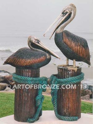 Taking a Break bronze statue of playful pelicans on bronze pilings