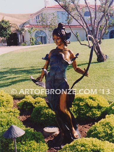 Diane monumental outdoor bronze statue of beautiful woman standing with flowers