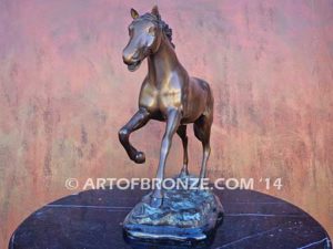 Running Free sculpture award of charging horse attached to a marble base
