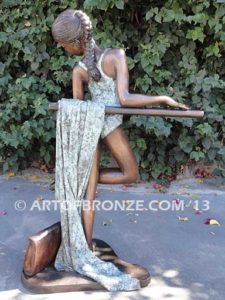 Rehearsal bronze sculpture featuring young ballerina practicing on rail