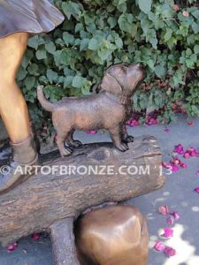Young Adventurers bronze sculpture of children playing on fallen bronze tree