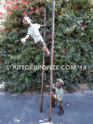 Picking Apples bronze sculpture of young boy holding up ladder for his brother climbing up