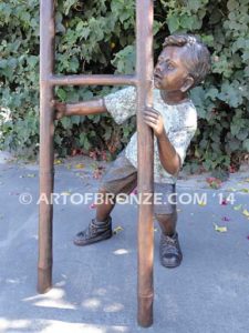 Picking Apples bronze sculpture of young boy holding up ladder for his brother climbing up