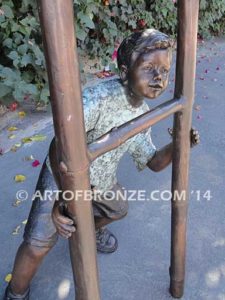 Picking Apples bronze sculpture of young boy holding up ladder for his brother climbing up