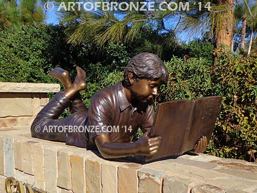 Best in His Class bronze statue of boy lying down reading book