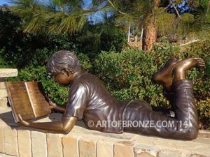 Best in His Class bronze sculpture of young boy reading his favorite novel