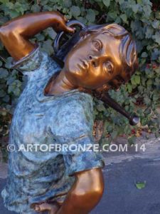 Strolling Along bronze sculpture of boy helping in garden watering flowers
