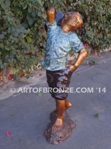 Strolling Along bronze sculpture of boy helping in garden watering flowers