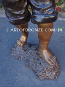 Strolling Along bronze sculpture of boy helping in garden watering flowers