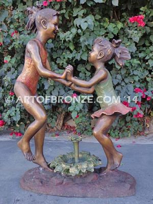 Dance Around bronze statue of two girls jumping around flower fountain