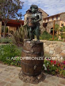 Harvest Time bronze sculpture of cherub boy standing on wine barrel with grapes