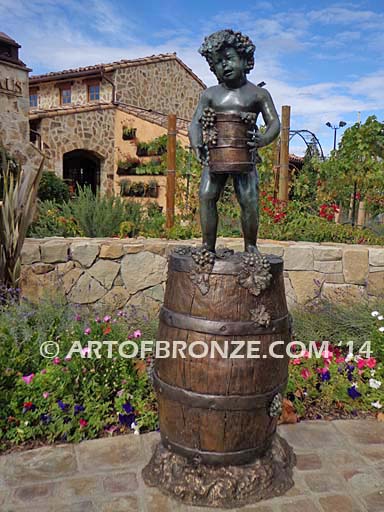 Harvest Time bronze sculpture of cherub boy standing on wine barrel with grapes