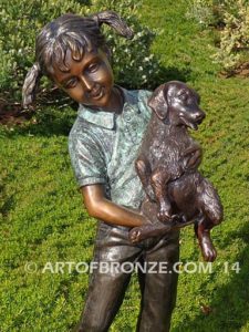 Play with Me Too bronze sculpture of girl holding dog with other dog chewing on her shoelace