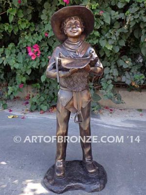 Saddle Up bronze sculpture of cowboy mounting saddle