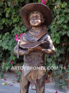 Saddle Up bronze sculpture of cowboy mounting saddle