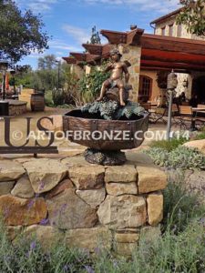 Special Reserve bronze sculpture fountain of cherub sitting on wine barrel