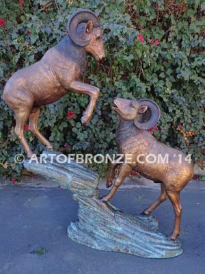 Clash of the Titans special edition, monumental outdoor rams clashing on bronze rock ledge