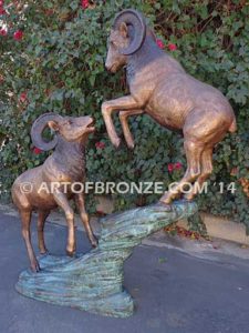 Clash of the Titans special edition, monumental outdoor rams clashing on bronze rock ledge