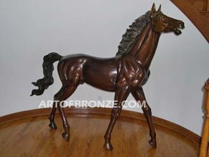 Prancing Delight sculpture of foal with flowing mane and tail with strong muscle details