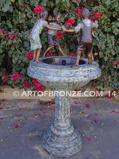 Playground Joy bronze fountain sculpture of kids dancing around