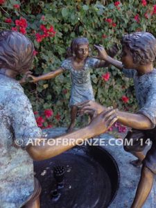 Playground Joy bronze fountain sculpture of kids dancing around