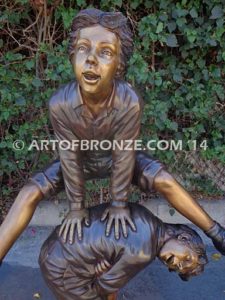 Leapfrog bronze sculpture of two kids playing leapfrog