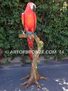 Scarlet Macaw outdoor statue of life-size wild Macaw on a branch