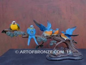 Bronze sculpture of five finches playing together on branch