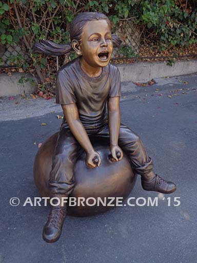 Hop Ball bronze sculpture of girl bouncing on hop ball