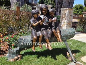 Special Touch bronze sculpture of three kids sitting on log with a injured baby bird in their hands