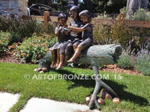 Special Touch bronze sculpture of three kids sitting on log with a injured baby bird in their hands