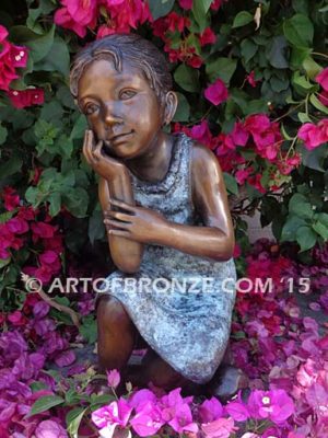 Cutie Pie bronze sculpture of sitting girl on knee daydreaming