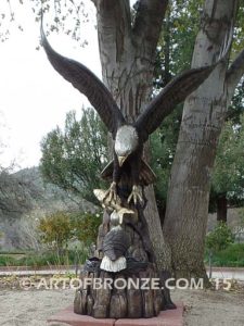 Dinner for Two* statue of a life-size bald eagle feeding its baby eaglet in nest